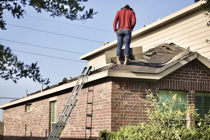 Professional roofer working on a residential roof in Kellers Court